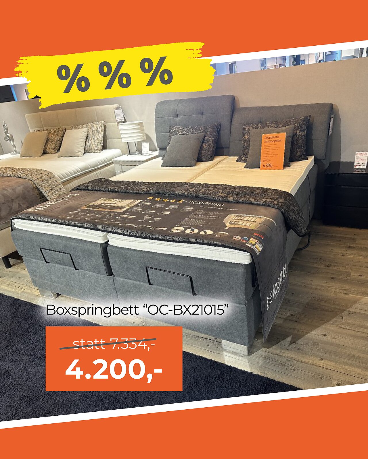 Boxspringbett mit grauem Stoffbezug, zwei Matratzen und Kopftei
